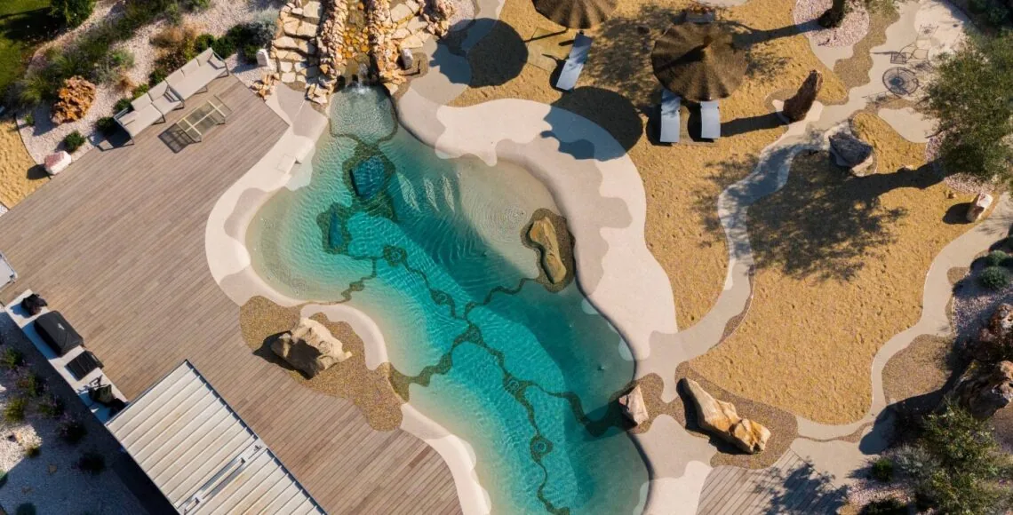 Aerial view of a beach-style pool showing the engineered stone surface and its flowing lines